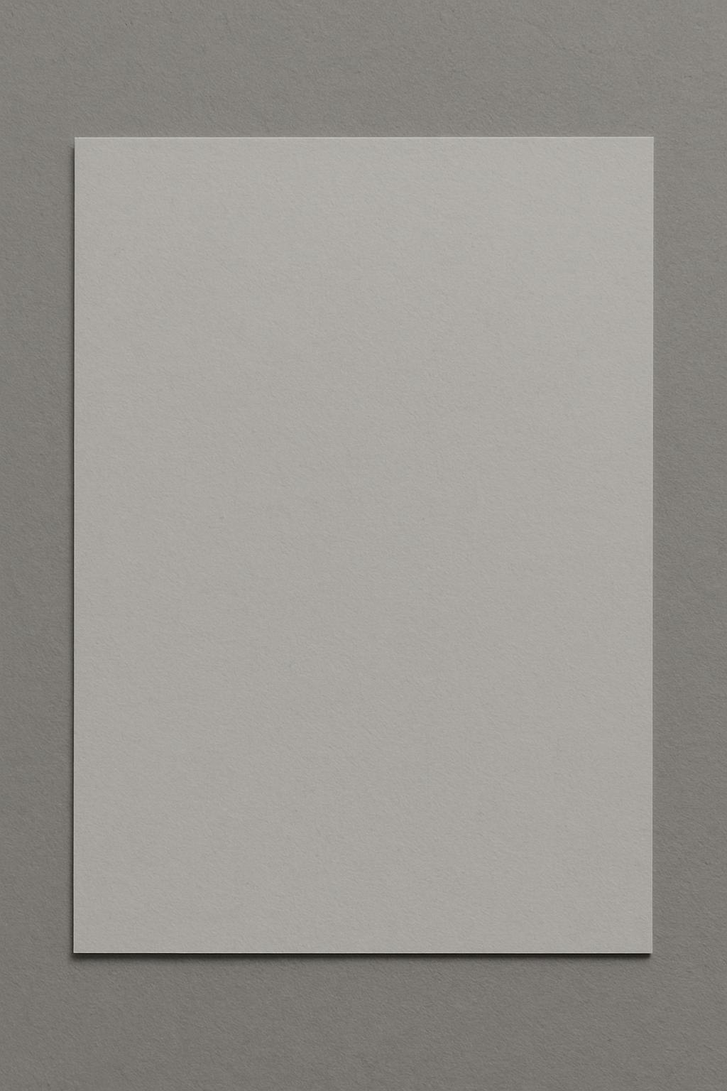A plain white piece of paper on a gray background.